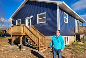 Heather Clare standing in front of her family's newly constructed home in Debert,
