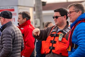 Matthew Duffy, executive director of Fish Safe NS, wearing a PFD, while speaking with Stuart MacLean, CEO of Workers' Compensation Board Nova Scotia, during a past safety demonstration for the fishing industry. CONTRIBUTED