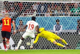 Thibaut Courtois of Belgium saves the penalty taken by Alphonso Davies of Canada.