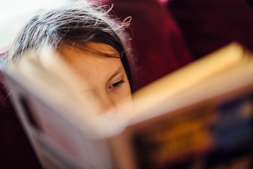 Stock image of a child reading. - Johnny McClung / Unsplash