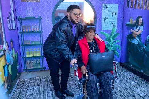 Halifax artist Marven Nelligan stands with grandmother Viola Dixon in front of the new Gottingen Street art installation dedicated to Nova Scotia businesswoman and civil rights icon Viola Desmond, which was unveiled on Wednesday.