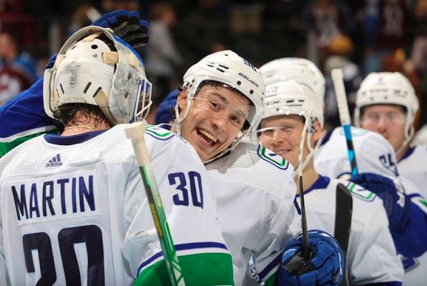  Andrei Kuzmenko and goaltender Spencer Martin of the Vancouver Canucks celebrate the victory against the Colorado Avalanche at Ball Arena on Nov. 23, 2022 in Denver, Colorado.