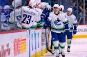  Vancouver Canucks right wing Ilya Mikheyev (65) is congratulated for a goal against the Colorado Avalanche during the first period of an NHL hockey game Wednesday, Nov. 23, 2022, in Denver.