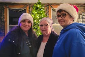 Tristen Tourout, left, Velma Acorn and Cassie Matheson stand in Acorn's home in Belle River. Tourout, Acorn's granddaughter, arranged for Matheson and others to help decorate Acorn's home while Acorn was away at chemotherapy. Logan MacLean • The Guardian