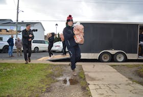 Brandon Cole helps carry in some carrots that were delivered from Prince Edward Island to the Glace Bay Food Bank on Wednesday. The entire Glace Bay Panthers hockey team showed up to carry the produce in as well as a large milk donation. GREG MCNEIL/CAPE BRETON POST