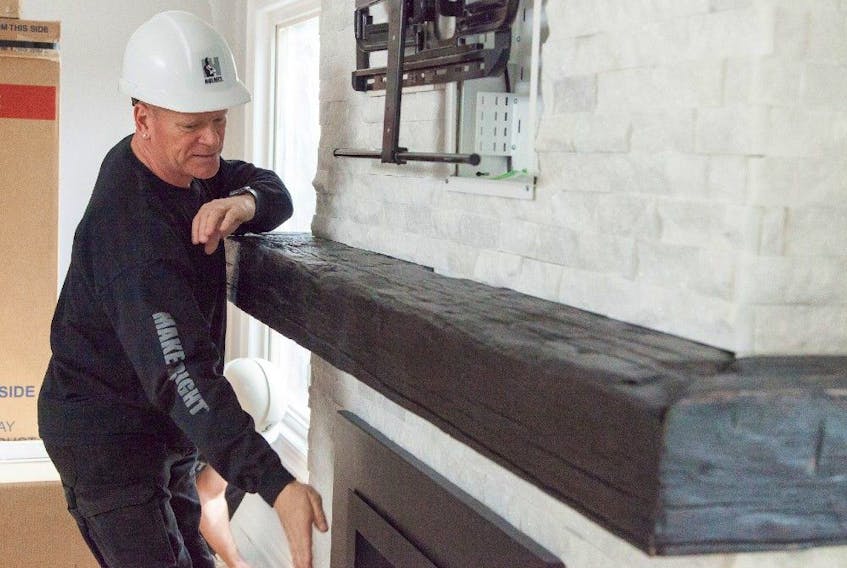 Mike Holmes on location for Holmes and Holmes, where he updated a wood-burning fireplace with a gas insert. 