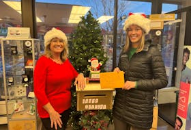Pauline MacIntyre, left, manager of the Canada Post retail office in Charlottetown and Charlotte Nicholson, tourism and events co-ordinator with the City of Charlottetown, mail a letter to Santa. Contributed