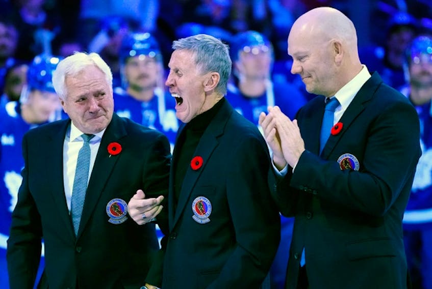Former Toronto Maple Leafs players and members of the Hockey Hall of Fame, Darryl Sittler, left to right, Borje Salming and Mats Sundin take part in a pregame ceremony prior to a game in Toronto, Friday, Nov. 11, 2022. 