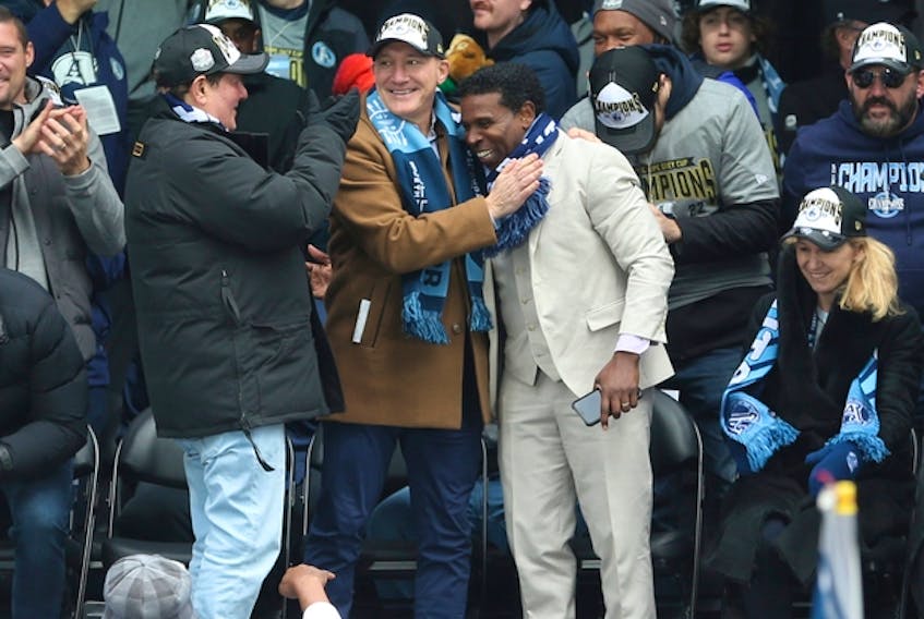  Toronto Argonauts GM Michael (Pinball) Clemons is hugged by team president Bill Manning as the Argos take the main stage at Maple Leaf Square for a victory rally to celebrate their Grey Cup championship, on Thursday, Nov. 24, 2022. JACK BOLAND/TORONTO SUN