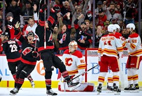 RALEIGH, NORTH CAROLINA - NOVEMBER 26: Brett Pesce #22 of the Carolina Hurricanes celebrates aftetr scoring the game-winning goal against the Calgary Flames during the first period of their game at PNC Arena on November 26, 2022 in Raleigh, North Carolina.