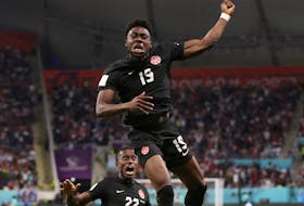Alphonso Davies celebrates scoring Canada's first goal at the World Cup on Sunday in Doha, Qatar. - CARL RECINE / REUTERS