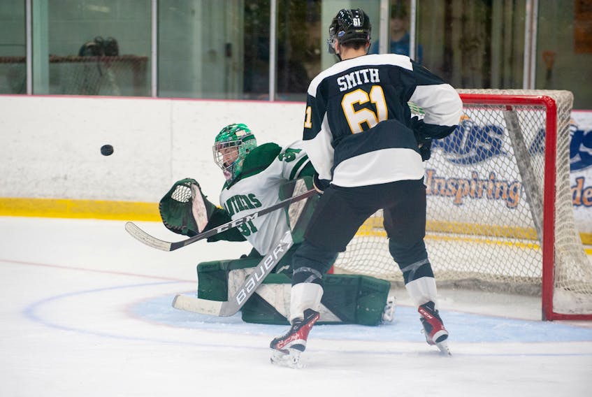 UPEI Panthers goaltender Lucas Fitzpatrick tracks a shot as the Dalhousie Tigers’ Zak Smith, 61, looks for a rebound during an Atlantic University Sport (AUS) men’s hockey game at MacLauchlan Arena in Charlottetown on Nov. 26. The Panthers, who won the game 6-3, close out the first-half schedule with two home games this week. Janessa Hogan Photo, UPEI Athletics • Special to The Guardian