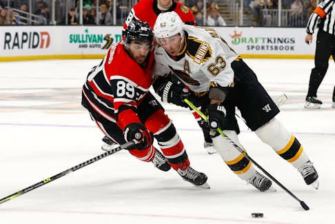 Nov 19, 2022; Boston, Massachusetts, USA; Boston Bruins left wing Brad Marchand (63) tries to get around Chicago Blackhawks center Andreas Athanasiou (89) during the first period at TD Garden. Mandatory Credit: Winslow Townson-USA TODAY Sports  Boston Bruins left-winger Brad Marchand (63) tries to get around Chicago Blackhawks centre Andreas Athanasiou (89) during the first period of a Nov. 19 game at TD Garden in Boston. - Winslow Townson-USA TODAY Sports