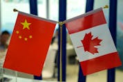 Chinese and Canadian national flags are seen during an exhibition in Shanghai, China.