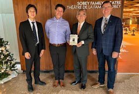 Japanese Embassy first secretary Takeshi Nukui, left, Confederation Centre of the Arts artistic director Adam Brazier, Japanese Ambassador Kanji Yamanouchi and centre CEO Steve Bellamy with a copy of Anne’s Cradle: The Life and Works of Hanako Muraoka. Contributed
