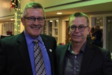 Curlers and former teammates Peter Gallant, left, and Robert Campbell catch up with each other after their induction ceremony into the P.E.I. Sports Hall of Fame in Charlottetown Nov. 25. Grant Harrison • Special to The Guardian