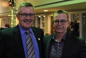 Curlers and former teammates Peter Gallant, left, and Robert Campbell catch up with each other after their induction ceremony into the P.E.I. Sports Hall of Fame in Charlottetown Nov. 25. Grant Harrison • Special to The Guardian