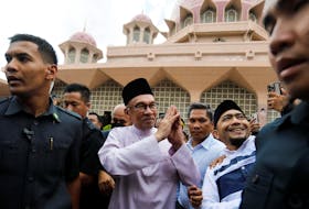 Newly elected Malaysia's Prime Minister Anwar Ibrahim meets supporters during his first public appearance, attending Friday prayer at a mosque in Putrajaya, Malaysia November 25, 2022. REUTERS/Hasnoor Hussain  Malaysia's newly elected Prime Minister Anwar Ibrahim meets supporters during his first public appearance, attending Friday prayer at a mosque in Putrajaya, Malaysia on Nov. 25. REUTERS/Hasnoor Hussain