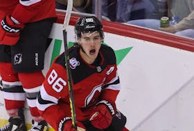 New Jersey Devils center Jack Hughes  celebrates after scoring a hat trick goal against the Washington Capitals during the third period at Prudential Center.  