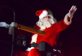 Santa Claus waves from the top of a fire truck during the annual Barrington and Area Chamber of Commerce parade of lights on Nov. 26. KATHY JOHNSON