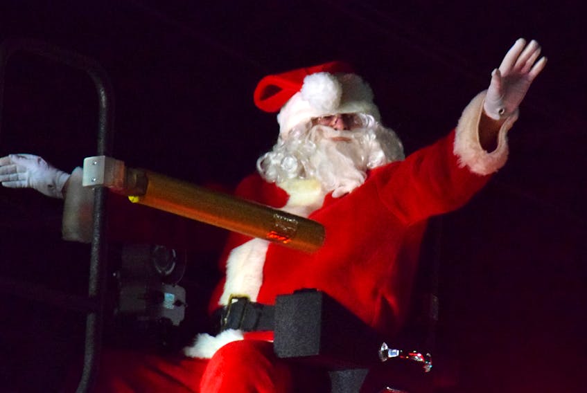 Santa Claus waves from the top of a fire truck during the annual Barrington and Area Chamber of Commerce parade of lights on Nov. 26. KATHY JOHNSON