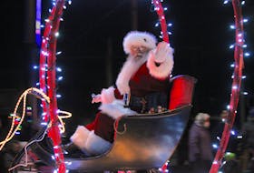 Jolly Old Saint Nicholas waves to people near the intersection of Cottage and Commercial streets who came out to watch Berwick’s Santa Claus Parade on Nov. 26.  
Jason Malloy