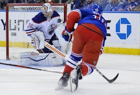 Oilers goaltender Jack Campbell makes a save against Rangers’  Vincent Trocheck on Saturday.