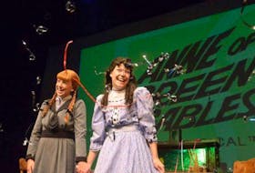 Anne Shirley, left, played by Katie Kerr, and Diana Berry, played by Jessica Gallant, smile as streamers are dropped to celebrate the 50th anniversary of Anne of Green Gables - The Musical in 2014. Contributed