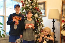 For the last eight years, Nolan, left, Jonah and Ellis Ferrish have made and sold Christmas ornaments to raise money for Prince County Hospital. – Kristin Gardiner
