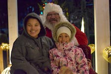 Tyson Gardner, 12, and Kaylee Walters, 5, both from Falmouth, were happy to have their photo taken with Santa after the parade Nov. 26 in Windsor.  
Aimee Alden