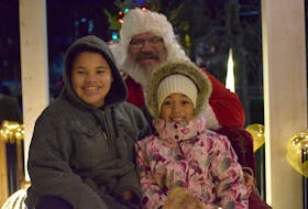 Tyson Gardner, 12, and Kaylee Walters, 5, both from Falmouth, were happy to have their photo taken with Santa after the parade Nov. 26 in Windsor.  
Aimee Alden