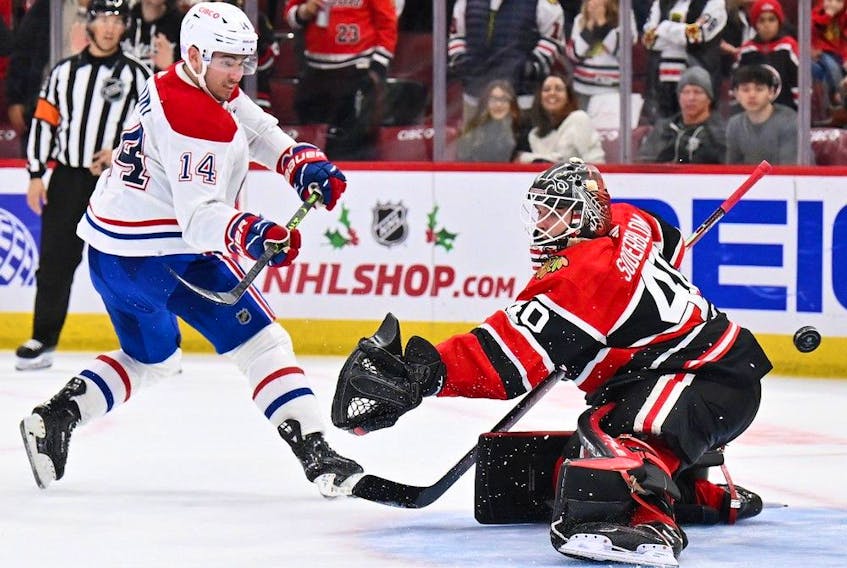 Nick Suzuki of the Montreal Canadiens scores in the shootout on Arvid Soderblom of the Chicago Blackhawks at United Center in Chicago on Nov. 25, 2022.