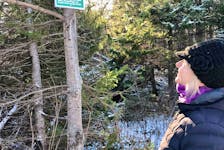 Petra Corlett of Belfast stands near a trail in P.E.I. where she posted a sign warning other trail users that animal traps may be in use in the fields and woods adjacent to the public pathway. The action follows a dog that was killed in Charlottetown on Nov. 2 by an illegally set animal trap. Contributed