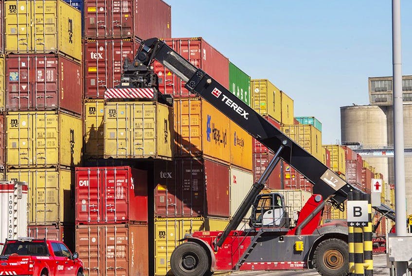 Containers are stacked at the Port of Montreal. Statistics Canada says real gross domestic product grew at an annual rate of 2.9 per cent in the third quarter. 