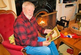 George Dalton sits by the original soapstone fireplace from the Lefurgey House, which was the family home from 1924 to the 1960s. He reads an original Holman’s Department Store catalogue, where his family used to shop for Christmas items. - Contributed