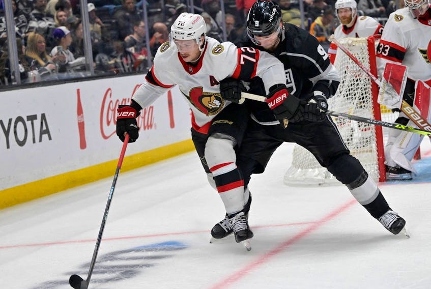 Ottawa Senators defenceman Thomas Chabot (72) and Los Angeles Kings right wing Adrian Kempe (9) battle for the puck in overtime at Crypto.com Arena.