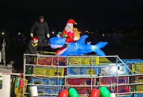 The crew of Easy Bay No.1, tie down an inflatable Santa and Shark on their stack of traps before they head out  on dumping day for the zone 33 lobster season in Eastern Passage Tuesday November 29, 2022.

TIM KROCHAK PHOTO