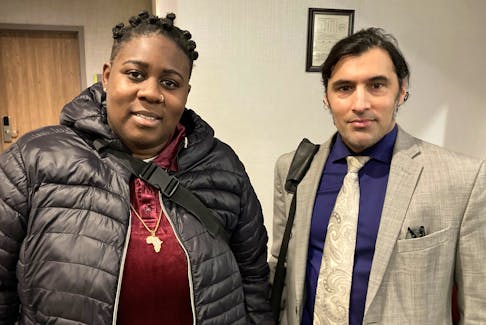 Kayla Borden and lawyer Asaf Rashid pose for a photo Tuesday, Nov. 29, 2022, outside the Nova Scotia police review board hearing into a complaint of wrongful arrest brought by Borden. The hearing is being held at a Dartmouth hotel. - Francis Campbell photo