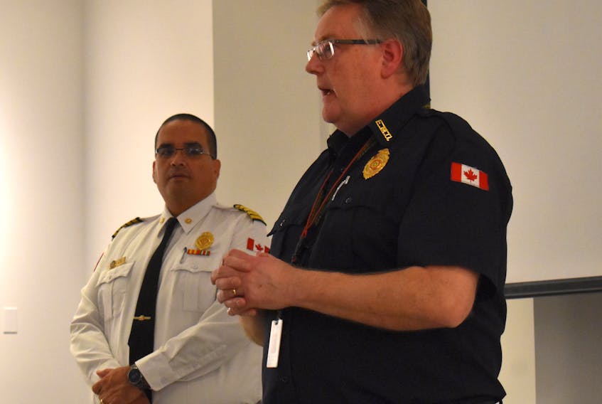 Bruce MacDonald, manager of emergency management with Cape Breton Regional Fire and Emergency Services, right, speaks to the crowd of about 50 people at the northend Sydney community group’s meeting about the July gasoline spill at the Imperial Oil tank farm in Sydney. JEREMY FRASER/CAPE BRETON POST.