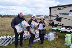 The Nova Scotia SPCA gave away free pet food to people in Pictou County on Giving Tuesday. From left are Nova Scotia SPCA Development Officer Creston Rudolph, Marsha Sobey and Jaqueline Sobey. Marsha Sobey is campaign chair for the new North Nova SPCA building that's going to be constructed in Stellarton.