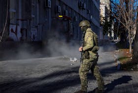 A Ukrainian serviceman patrols Kyiv after a Russian artillery strike in this file photo. The war has demonstrated the evolution of battlefield tactics, writes columnist Scott Taylor. - Reuters