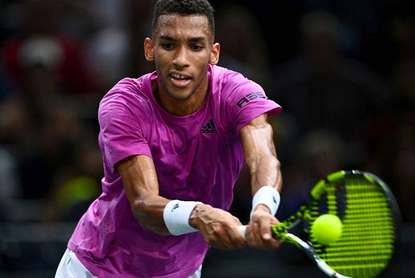 Montreal's Félix Auger-Aliassime plays a backhand return during match against France's Gilles Simon at the Paris Masters 1000 on Nov. 3, 2022.