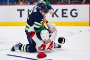  Vancouver Canucks defenceman Luke Schenn (2) fights with New Jersey Devils forward Miles Wood (44) in the second period at Rogers Arena.