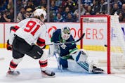  New Jersey Devils forward Dawson Mercer (91) scores on Vancouver Canucks goalie Thatcher Demko (35) in the second period at Rogers Arena.