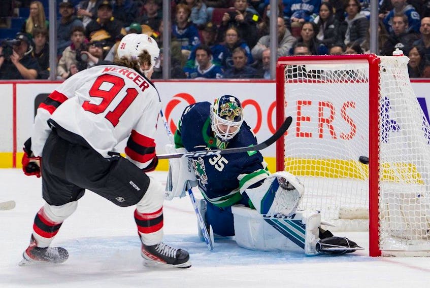  New Jersey Devils forward Dawson Mercer (91) scores on Vancouver Canucks goalie Thatcher Demko (35) in the second period at Rogers Arena.