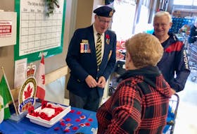 Larry Wall, back left, talks to a couple while giving out Remembrance Day poppies for donations at the Sobeys on Prince Street Thursday morning. The branch secretary of the Ashby Legion in Sydney said their annual poppy campaign is doing well so far. Wall's father was a legion member, which is why he got involved more than 25 years ago. His son, Bill Wall, is a veteran who served three tours in Afghanistan. NICOLE SULLIVAN/CAPE BRETON POST