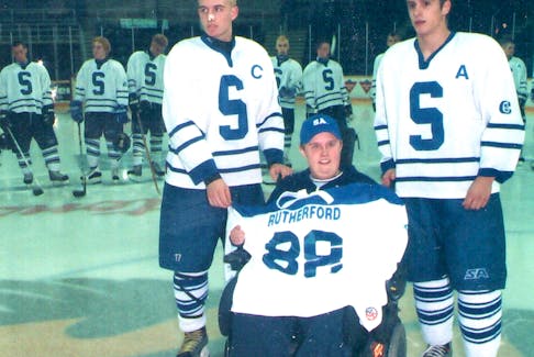 Trevor Rutherford, centre, held many roles with the Sydney Academy hockey team through the years. In 2013, he was named honorary chair of the Blue and White tournament in recognition of his efforts. He's shown with Derrick Hanna, left, and Ryan Oakley. CONTRIBUTED