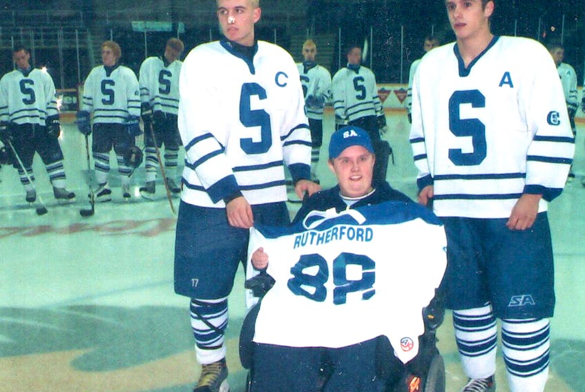 Trevor Rutherford, centre, held many roles with the Sydney Academy hockey team through the years. In 2013, he was named honorary chair of the Blue and White tournament in recognition of his efforts. He's shown with Derrick Hanna, left, and Ryan Oakley. CONTRIBUTED