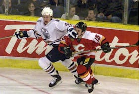 Oilers' Janne Ninimaa gives Flames' Martin St. Louis the business during a game in February 2000. St. Louis began his career in Calgary before achieving superstar status after signing with the Lightning as a free agent that July.