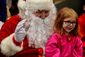 Santa was more than happy to pose for photos as family and friends gathered to snap pictures of their loved ones. Pictured here is four-year-old Emberly Lyons.